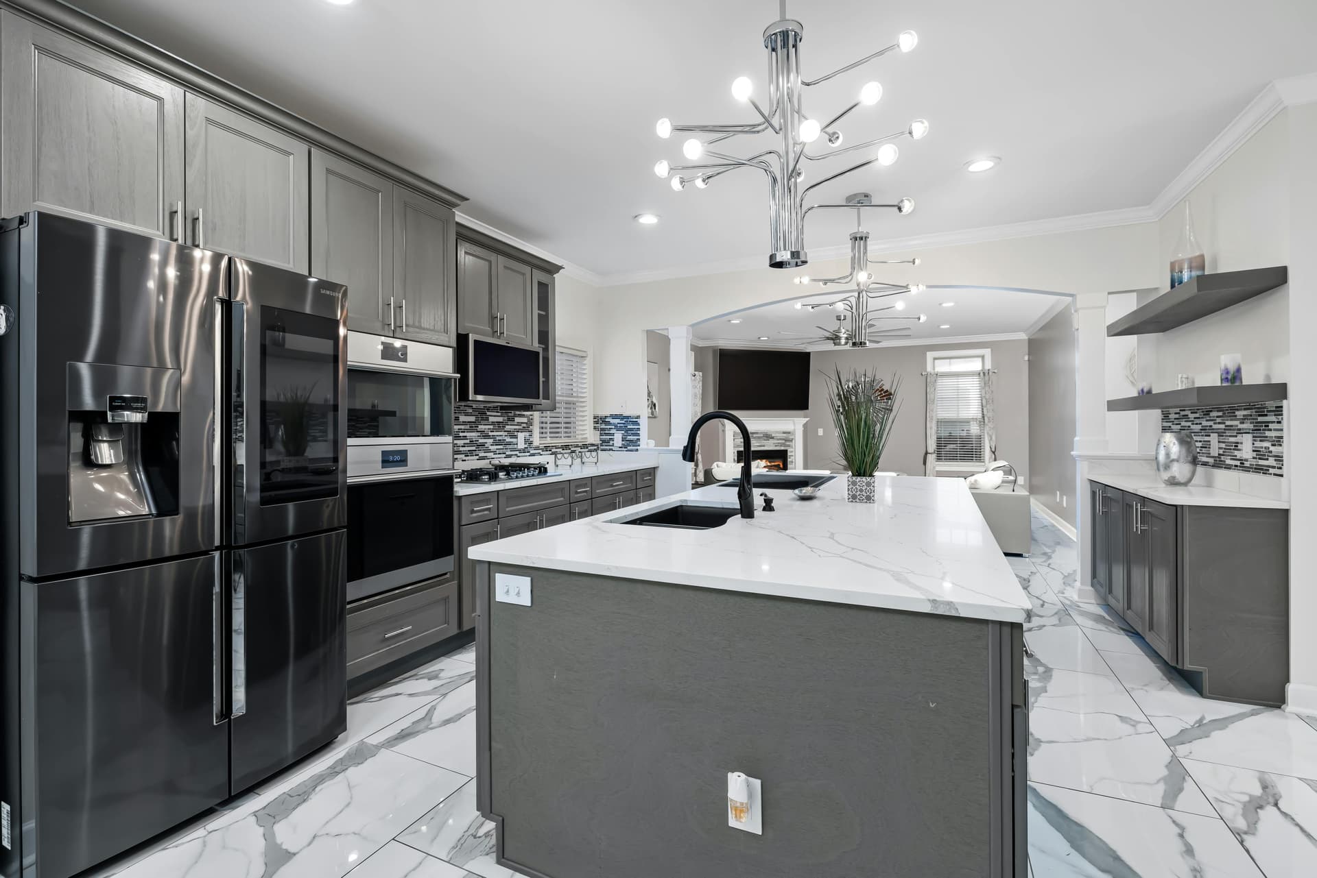 Contemporary kitchen remodel with dark gray cabinets and marble floors in Lancaster, Ohio