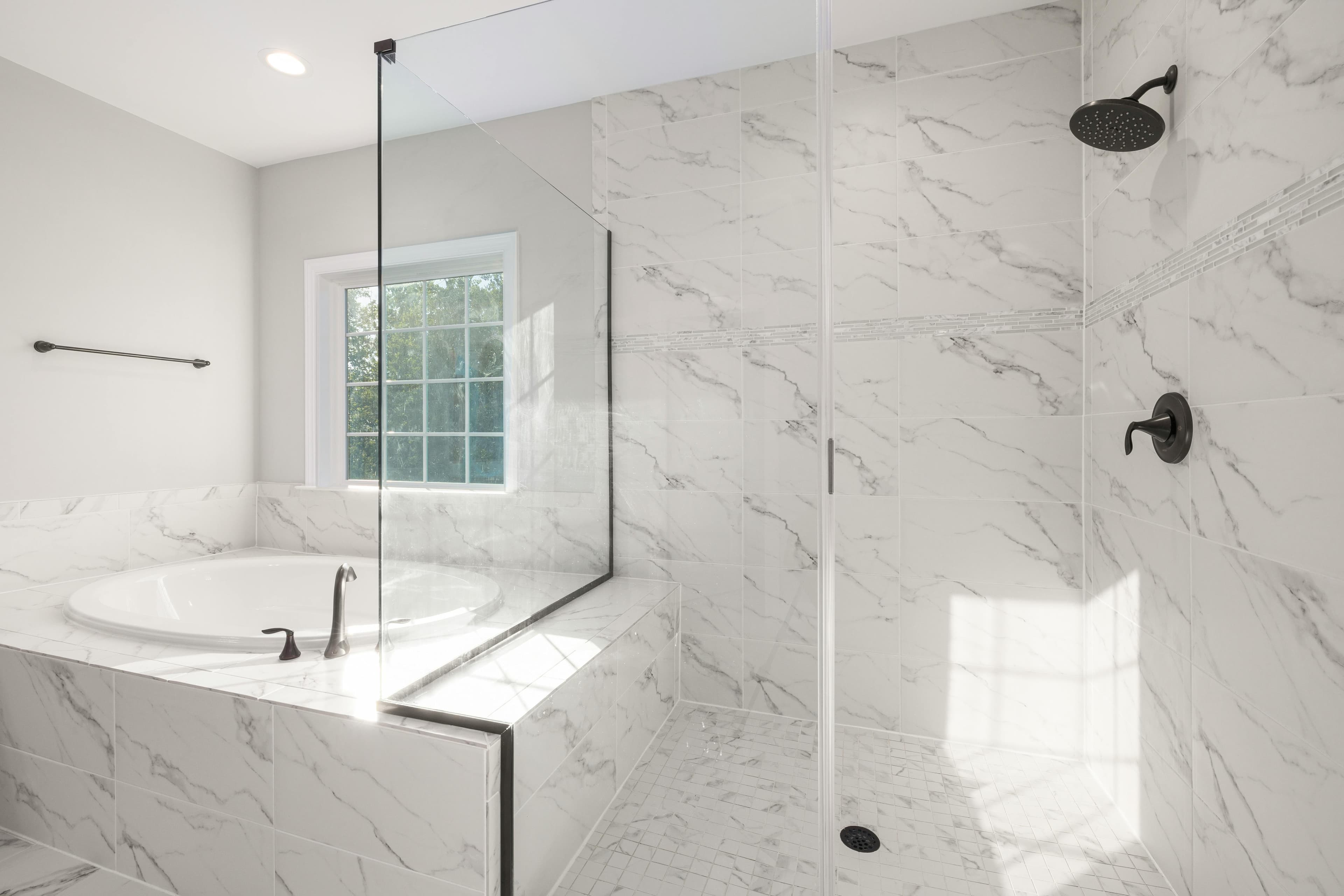 Luxury master bathroom with marble tile and soaking tub in Lancaster, Ohio