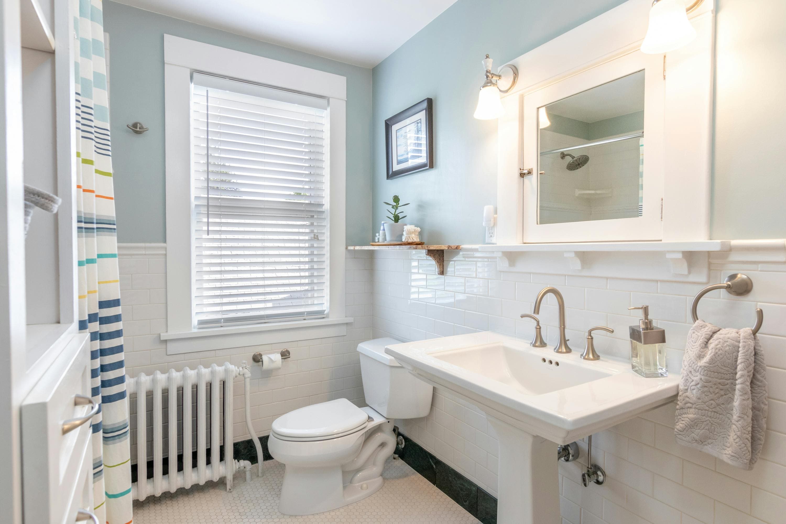 Classic white subway tile bathroom with pedestal sink in Lancaster, Ohio