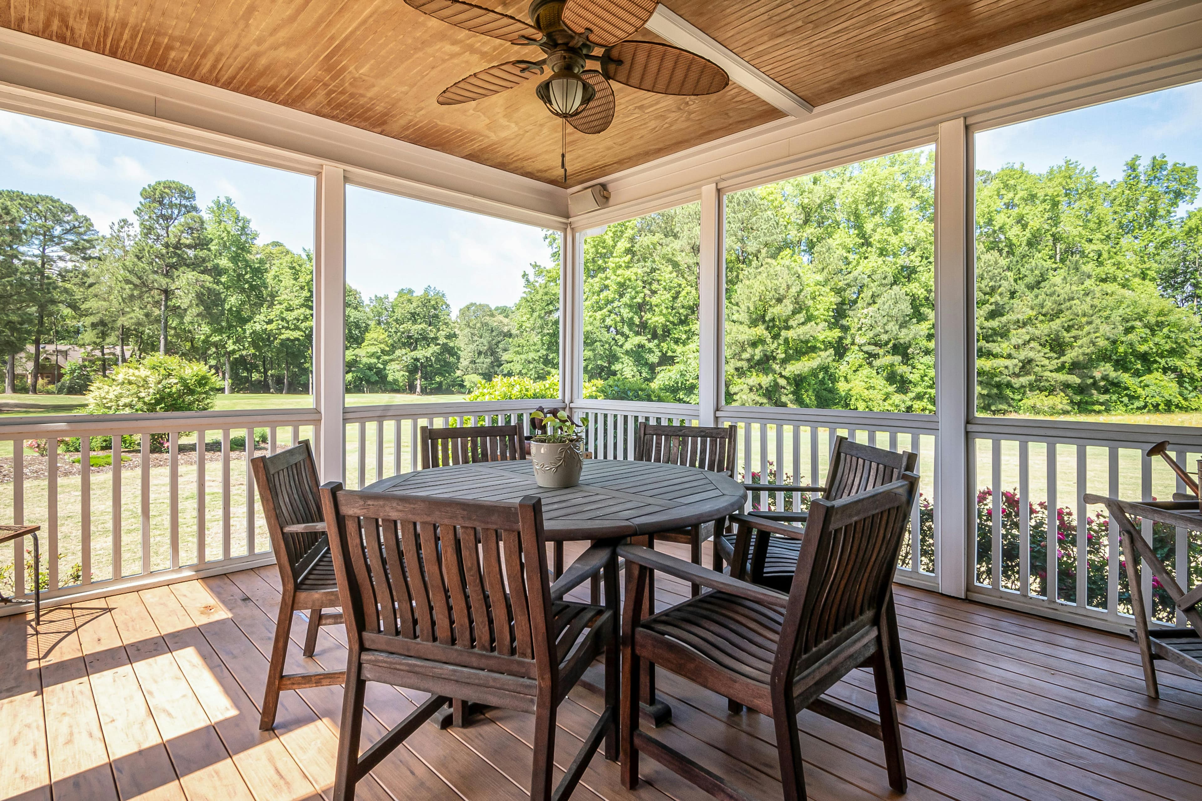 Covered screened porch with hardwood decking and outdoor dining in Pickerington, Ohio