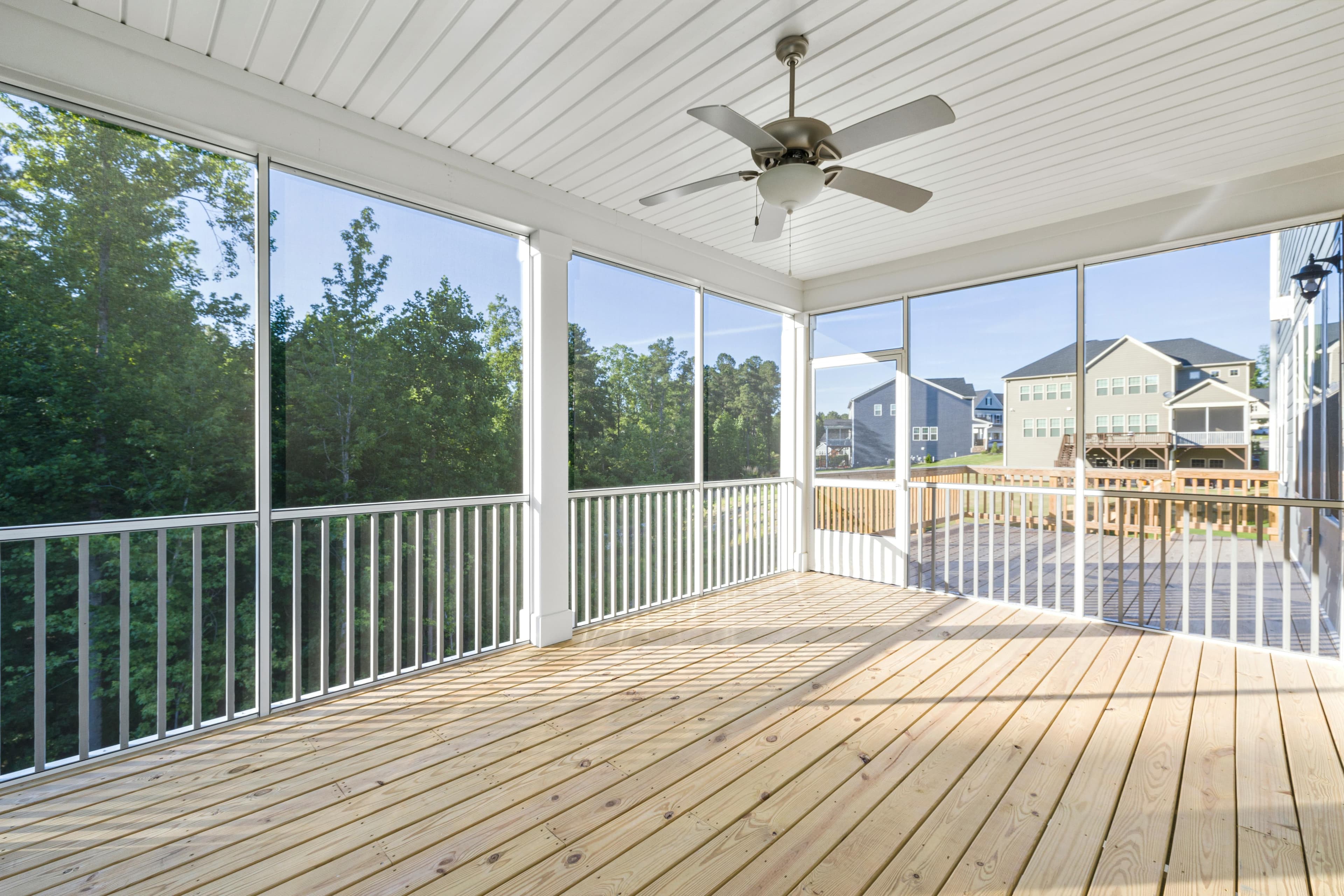 White screened porch with wood floor and ceiling fan in Pickerington, Ohio