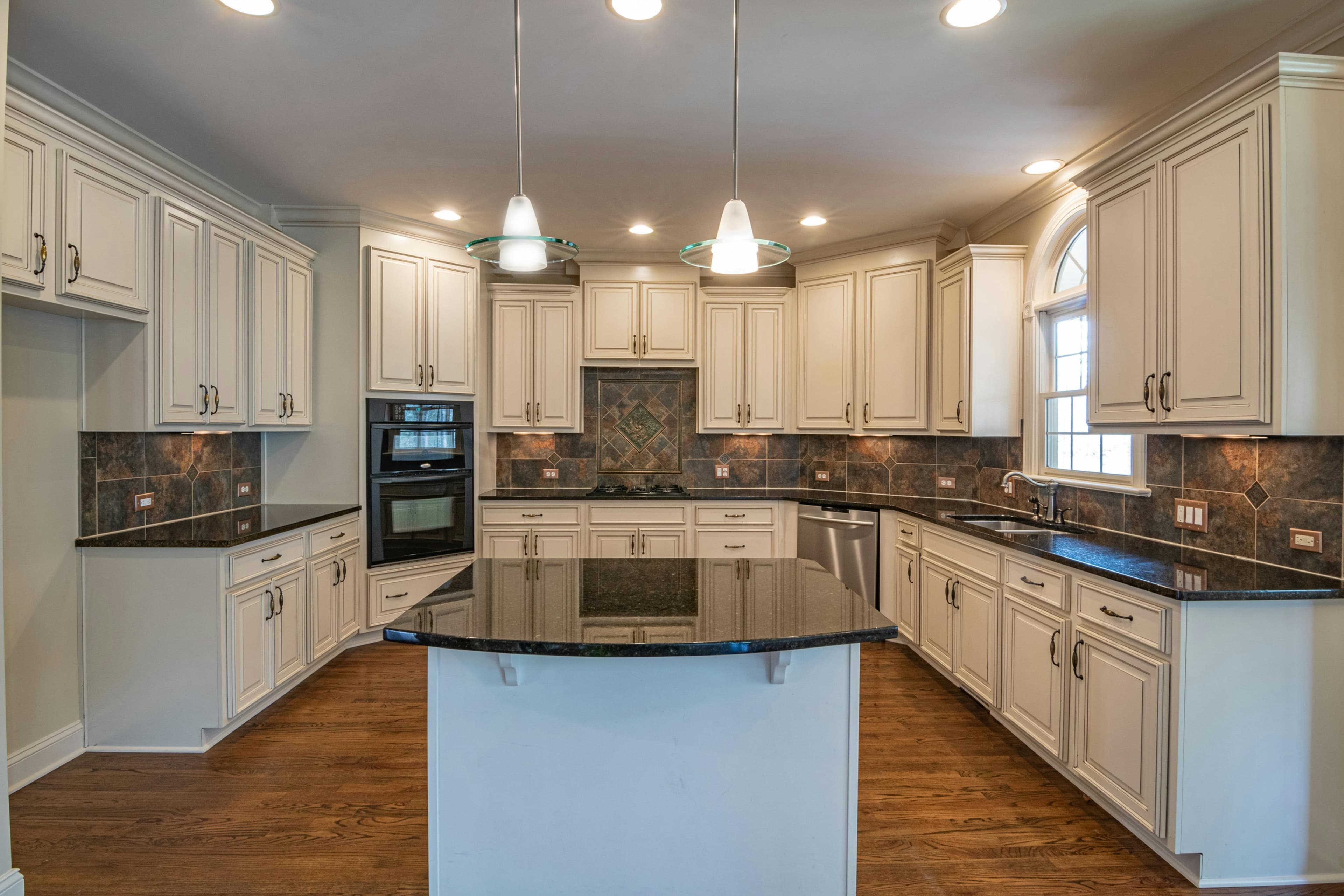 Custom kitchen remodel with cream cabinets and dark granite countertops in Lancaster, Ohio