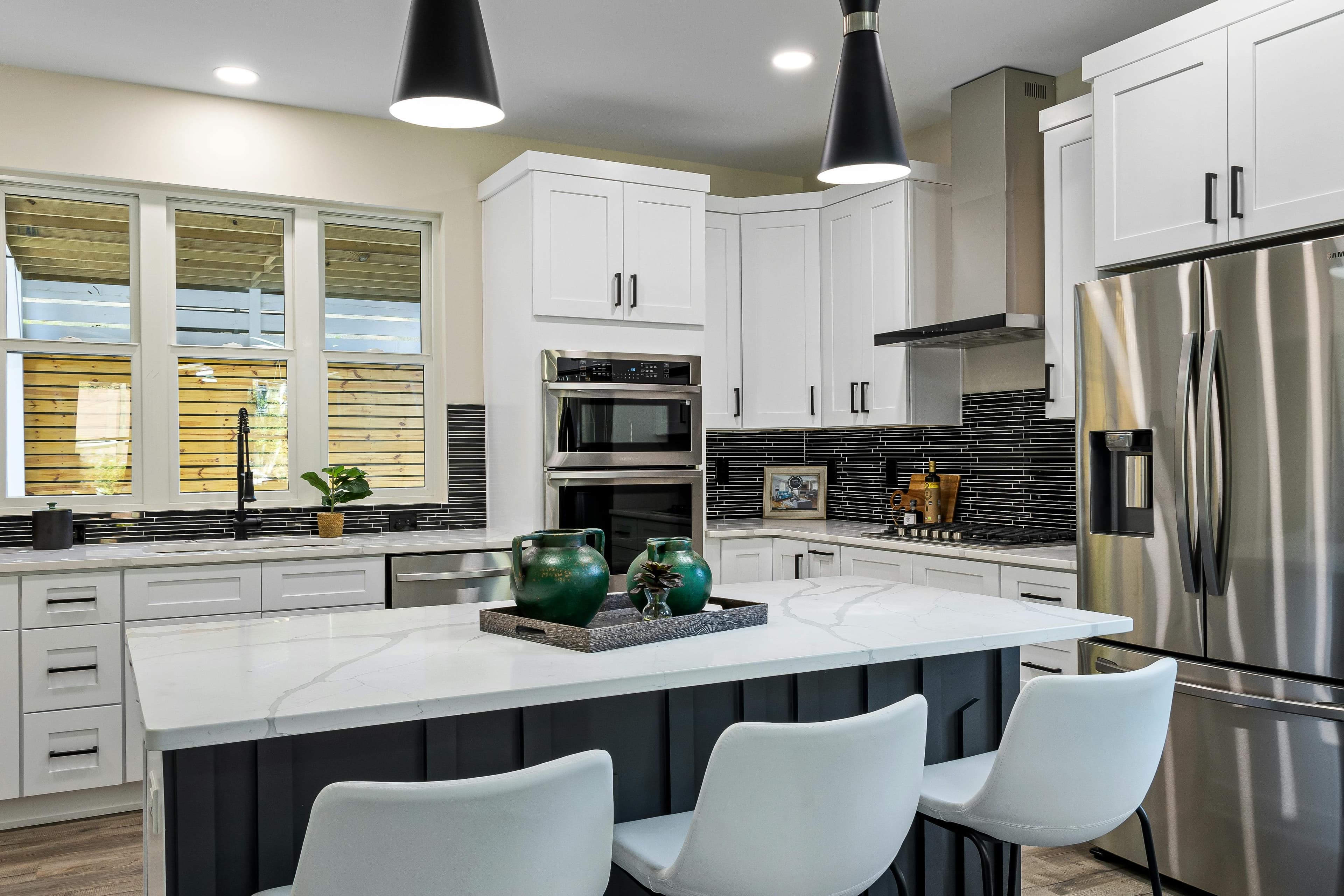 White kitchen with quartz island and black pendant lights in Lancaster, Ohio