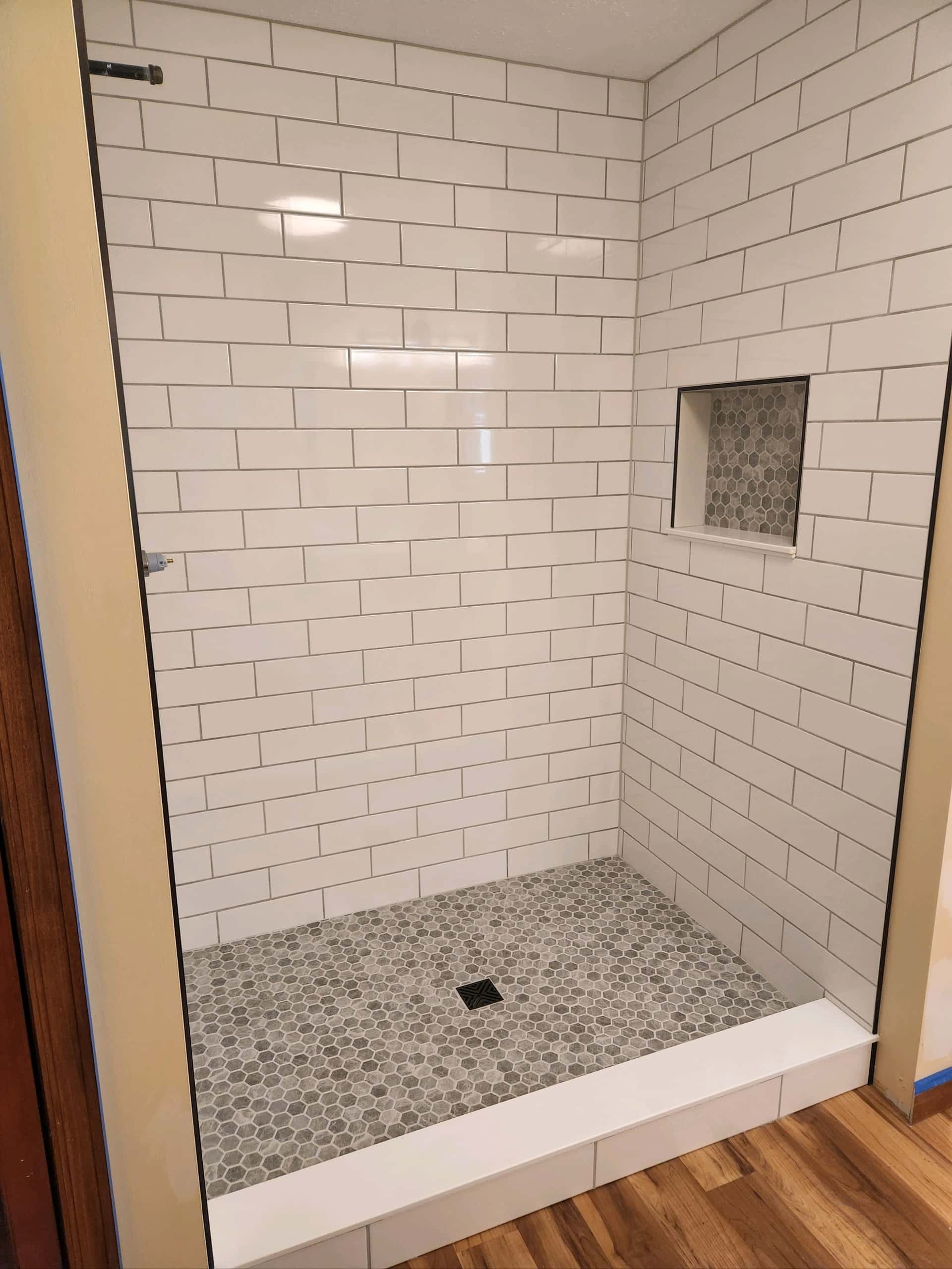 Walk-in shower with white subway tile and black frame glass in Lancaster, Ohio